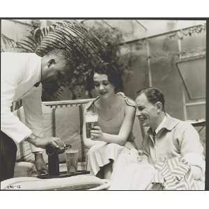  Man and woman being served beer by a black waiter,c1933 